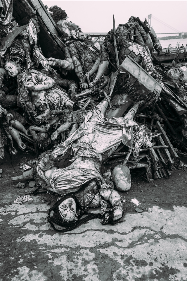 Fate of the Gods - For the sake of efficiency (with constant traffic of life-sized deities arriving at the ghat throughout the day), the deities are fished out of the water feet from where they were dumped. A microcosmic ritual mirroring the Hindu belief in reincarnation, the gods are added to the divine pile of cloth and clay, waiting, as they must, another 51 weeks to be reborn for next year's Durga Puja.