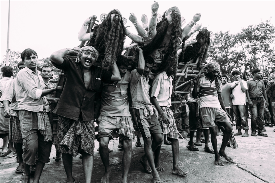 Baptism - After the deities have been on display in elaborate and colourful dress around the city for the festival week, they are brought back to the Ganges. For this whole day, there are several popular ghats along the river bank where truckloads of locals arrive amid the throng of bhajans and the ecstasy of celebration. Colourful powder is thrown in the air, as people sing and dance in the street. Once the deities are offloaded, the men bring them down to the water. A microcosm of the Hindu idea of reincarnation, once the festival is over, the deities are unceremoniously and dumped in the Ganges, from whence they came. 