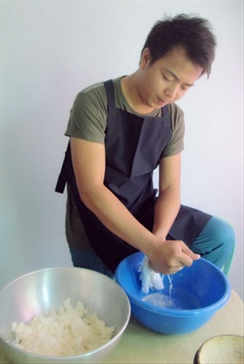Drying up the grinded cassava by squeezing its juice