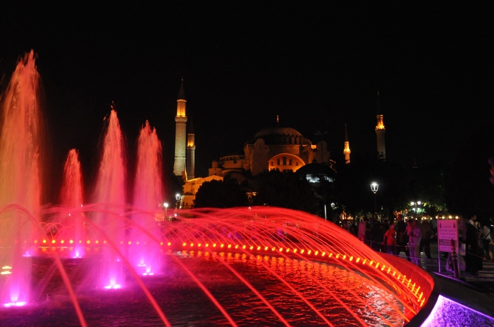 everything seems quiet in the sultanhamet´s park and background the ancient basilica of saint sofia  framed by the lights and color fountain, the  Muslim families gather to break the fast together      before the dusk in a one Ramadan´s day