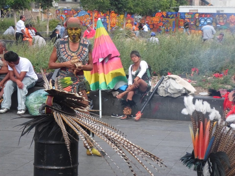A 'conchero' dancer is getting prepared for the ceremony he is about to perform. It is common to see street artists doing rituals based on Pre-Columbian beliefs outside the ruins of Templo Mayor.