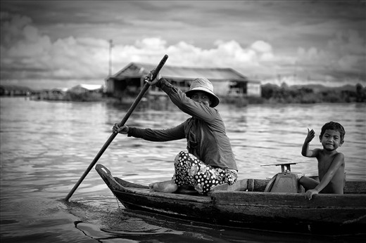 This is one of many families selling freshly caught shrimps. The mother paddles around the village, while her son helps her out with the weighting. Other families sell fruit and vegetables, chickens and fish, drinks, while karaoke bars, ice factories and churches floats around all tied together forming waterways and canals.