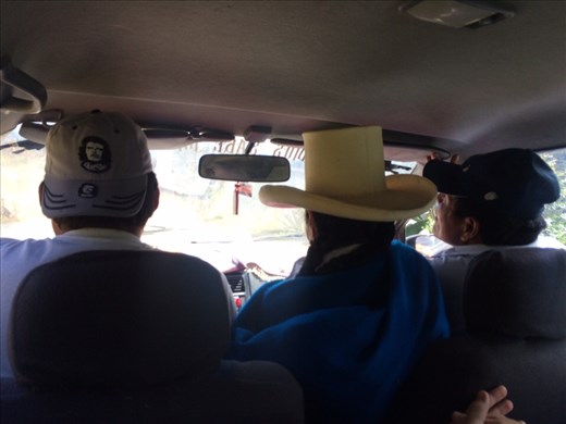 Very typical, Peruvians know how to maximize space in buses and taxis! I think the record so far is 5-6 people in one row. Here they squish 2 people somehow into the front passenger seat. Btw, the Andean Quechua people of the Cordillera Blanca wear big hats and colorful clothes. 