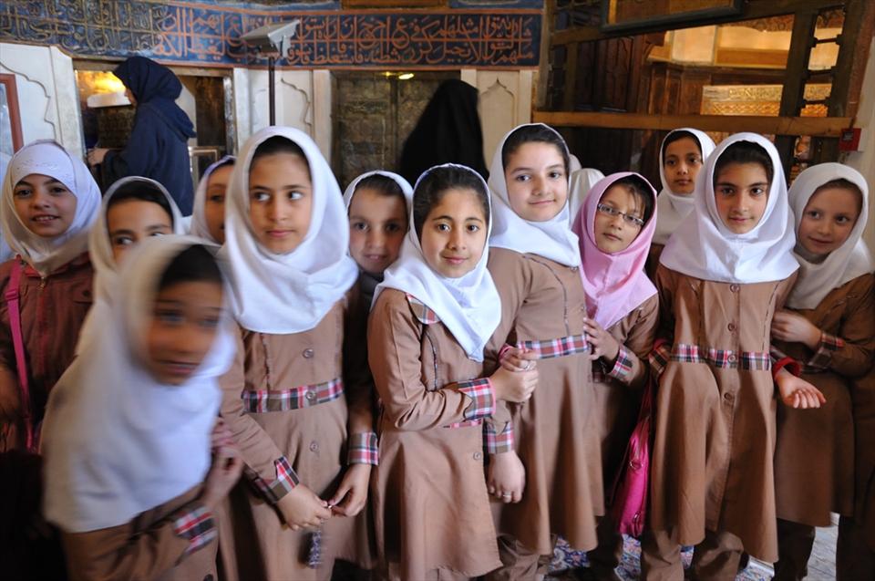 Whenever I pass a group of schoolchildren, I greet them with a wave and say, ‘Salam’ (Persian for hello), which encourages them to return the greeting. Generally, I do not linger unless the occasion requires it. 

Such an occasion arose when I met a large class of schoolgirls inside the Shaikh Safi Mausoleum in Ardabil. They had separated into smaller groups of friends who peeked at me with excited curiosity. I greeted the group nearest to me then paused. Their eyes full of anticipation.  

‘My name is Fiona. I am from Australia.’ I held out my hand. After a few handshakes, the rest of the children approached, individually announced their names. We shook hands, gave each other high-fives. 

I took this photo before the entire class of 30 children or more, gathered in front of me. It was a special moment not interrupted by an attempt to capture it. This was the future of Iran.
