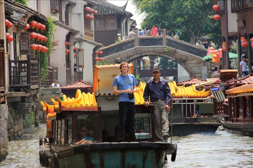 A College student enhances his Grand Canal tour with songs on his iPod. 