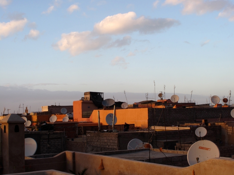 Inside the Marrakech Medina, antique Riads are fitted with new vogue television satellites. A local man finds peace and solitude while watching the sunset. At this time Maghrib, the evening prayer, begins to fill the airwaves throughout the city as silence falls at time of dusk.