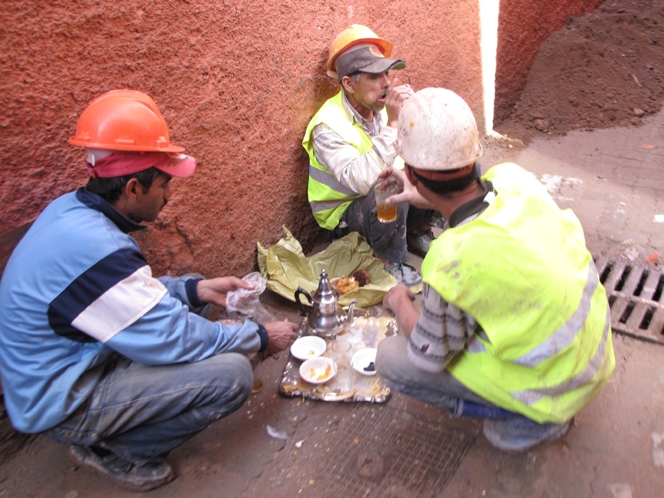 Berber construction workers finish eating a typical breakfast on a silver tray with teapot and crystal tea glasses. The (French) baguette is consumed with butter, honey, or jam and downed with the infamous “Berber Whiskey,” a strong mint tea topped with a high amount of sugar. Still a developing country, the Moroccans maintain cultural customs by eating their meals in style off of silverware instead of carbon waste.