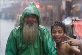 Old man with child smiling in the rain: by flood_in_manila, Views[892]
