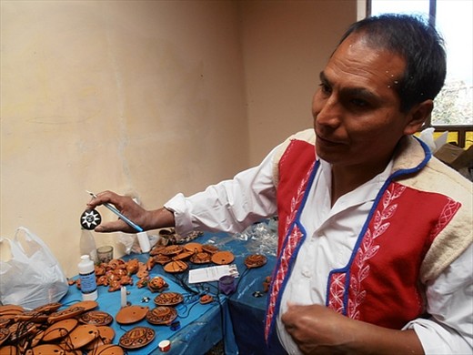 Vicente, ceramic artist, painting ocarinas