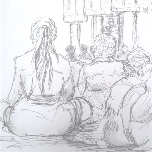 Watching the Dalai Lama on TV amongst the thangkas (hangings) in the temple