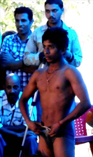 Young wrestler nervously waiting for his bout. He made it to the finals.