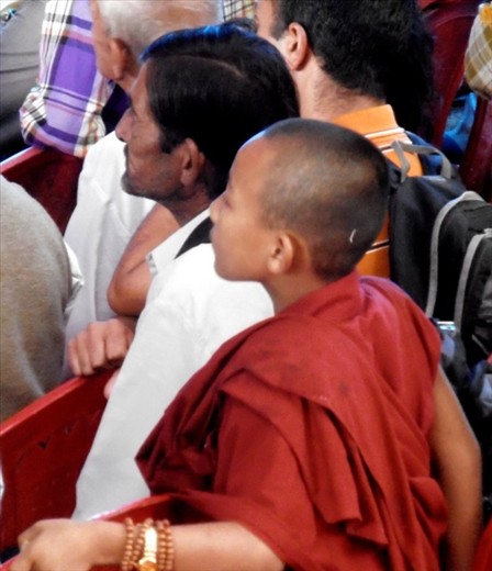 Young monk watching the wrestling