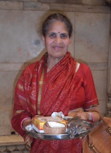 This devotee was very happy to have a rat on her tray of offerings.