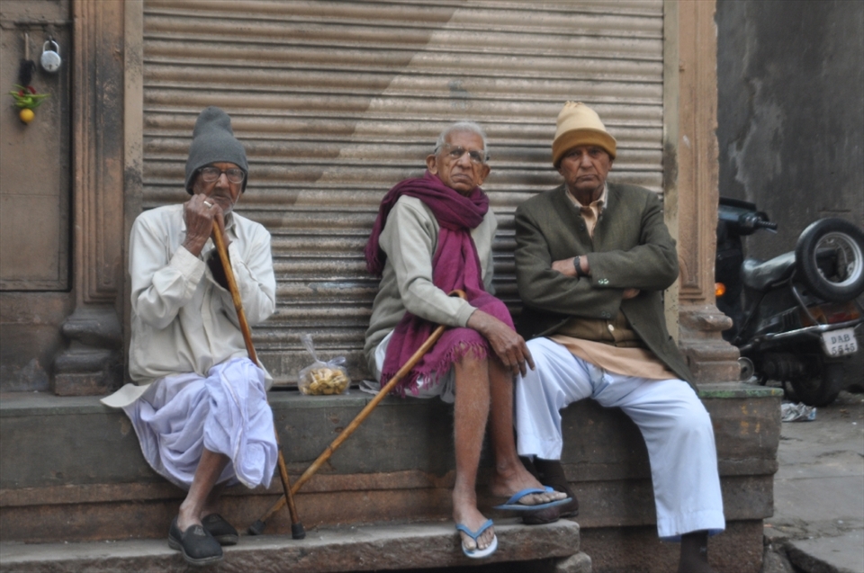 Men and their afternoon mutterings, gaze suspiciously into the camera. 