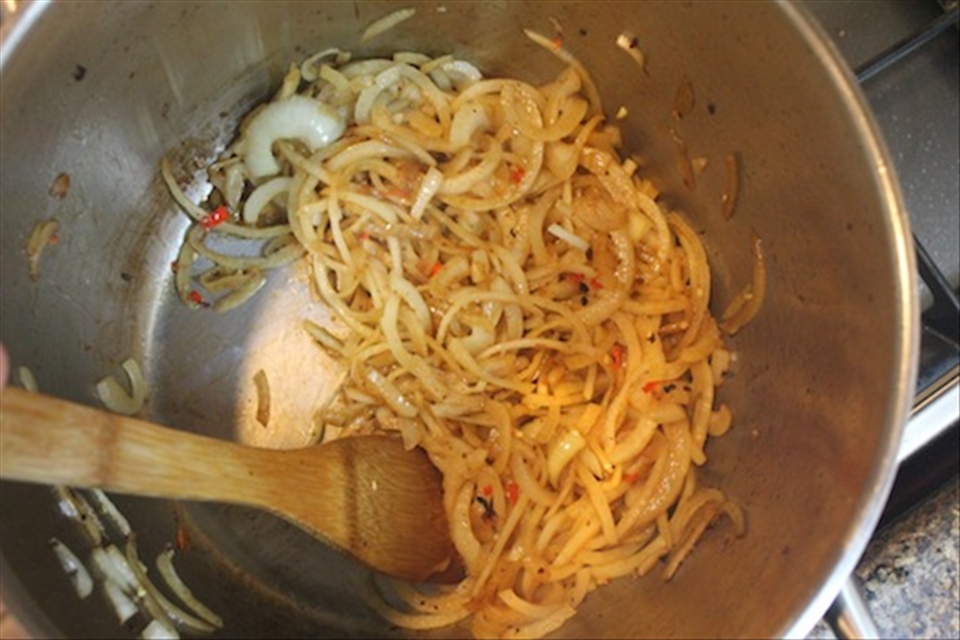 Saute the onion and chilies. Use a spatula to get the browned bits off the pot.
