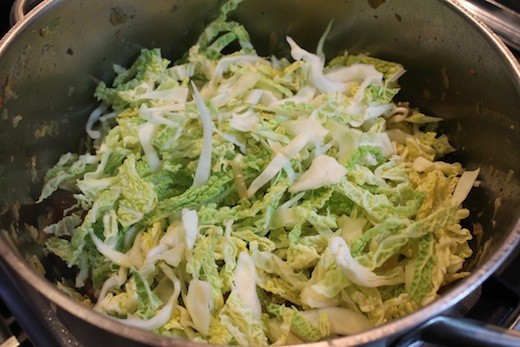 Add the pork back to the pot. Top with 1/3 of the cabbage. Cook until wilted.
