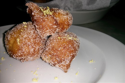 Beignets plated with lemon sugar. 