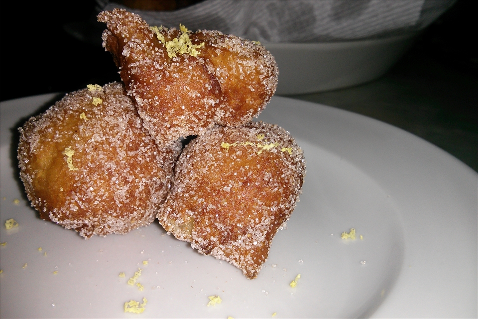 Beignets plated with lemon sugar. 
