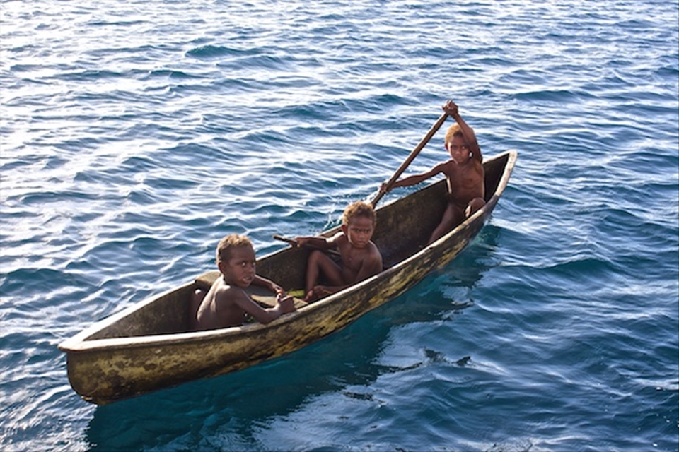The curious kids came up to us in canoes as we anchored.