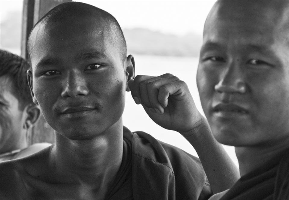 Bhuddist monk poses on the famed U Bein's Bridge in Amarapura.