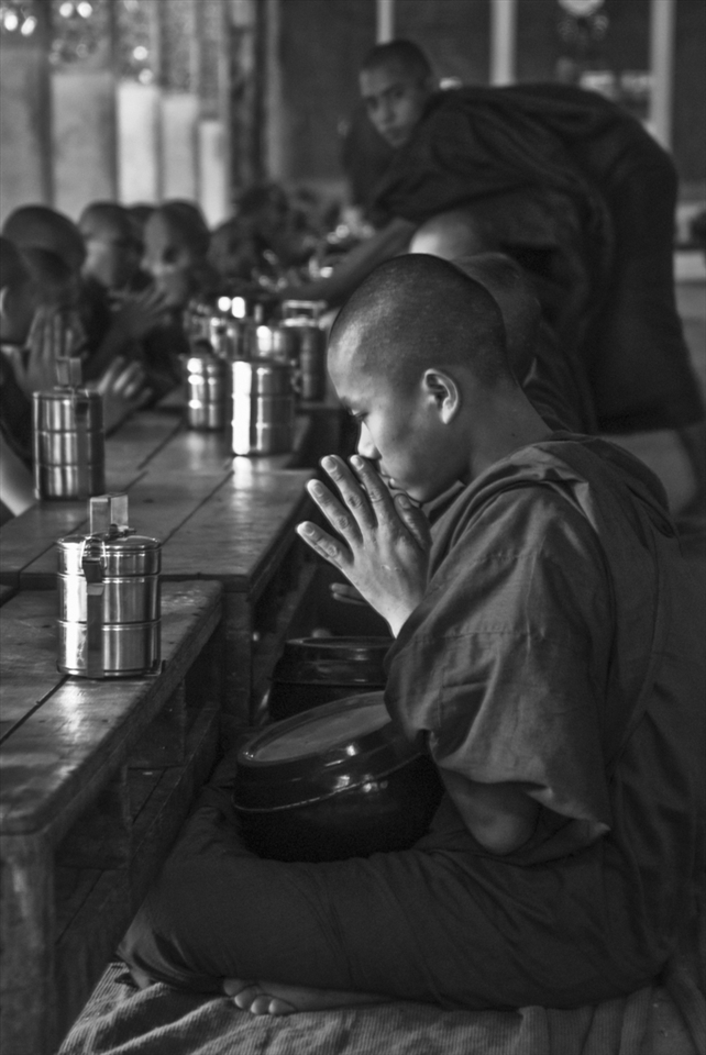 A novice monk prays before the midday meal, Kalaywa Tawya Monastery, Yangon.