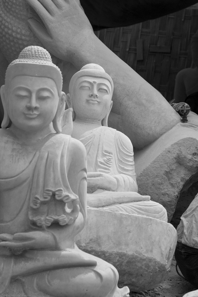 Marble Bhuddas wait to be finished in the workshops of Mandalay.