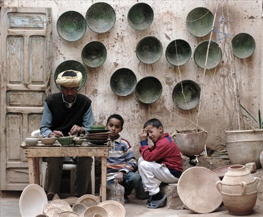 A potter and the fruit of his work.