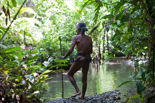 The Mentawai Islands are renowned as being one of the worlds finest surfing locations. Surfing enthusiasts are more than willing to transverse the globe to spend a week or two carving-up the spectacular wave-fronts, but many remain confined to their all-inclusive resort or live-a-board boat. Few become acquainted with the Mentawaian people who inhabit the jungle interior of the islands, continuing to adhere to their ancient traditions and hunter-gatherer lifestyle. These indigenous people and their animalist beliefs and traditions are under threat from (sometimes forceful) government intervention with the intention of relocating the Mentawaians into government-commissioned resettlement villages, designed to wash them of their “pagan” traditions. 