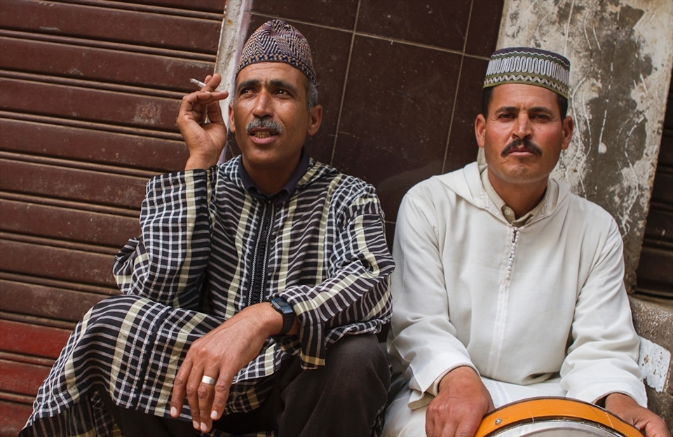 These two musicians take a break from playing and simply socialize around.