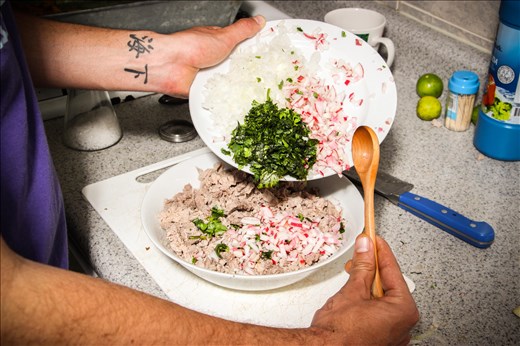 Mixing ingredients for salpicón