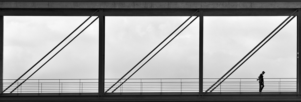 A photographer passes a bridge