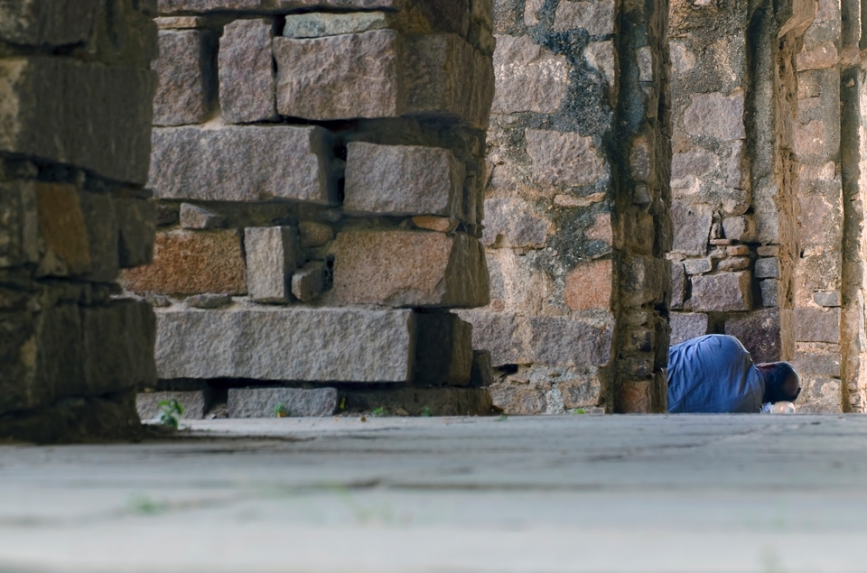 A worker taking an afternoon nap in the gallery of the tomb of seventh king. 

The persons's head was resting on a water bottle, I was wondering how people find their own ways to make themselves comfortable in any situation.