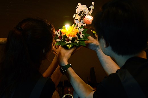 Loi Krathong is best enjoyed with the company of other people. Like this couple photographed, families, friends, and couples light their 'krathongs' together along the riverside.