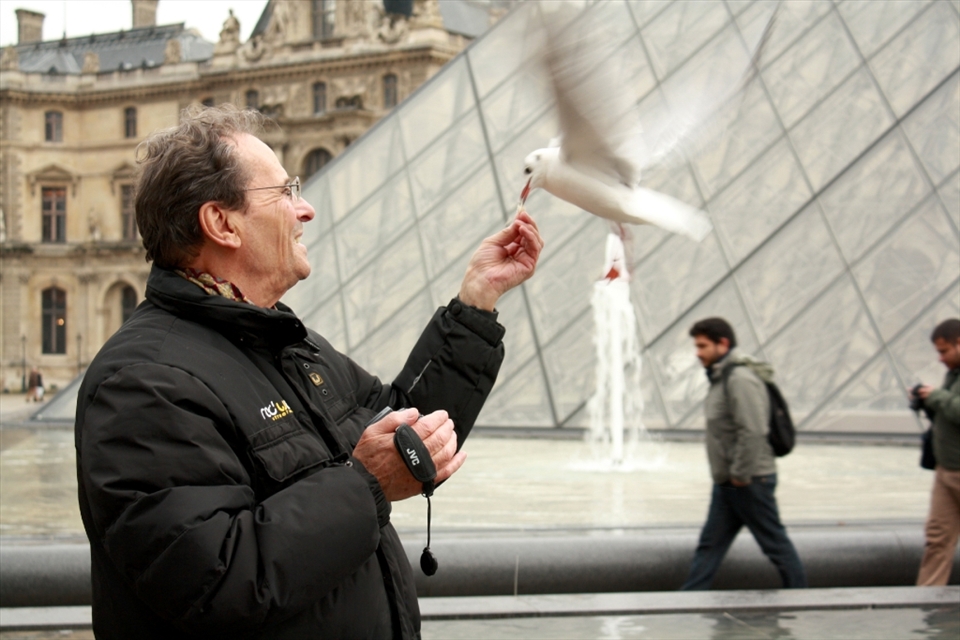 I was walking through the courtyard of the Louvre when I spotted this man standing next to one of the ponds. He was taking pleasure in feeding the seagulls while they took pleasure in perching on top of his head.