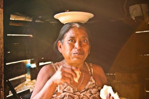 One of the things I remember most about this place is its food. Without using an enormous variety of ingredients,  the women manage to create remarkable flavors in their cuisine.  The African tradition of porting just about anything on the head makes its way into the kitchen of Divina who has the particular custom of eating directly from a plate precariously balanced upon her head.