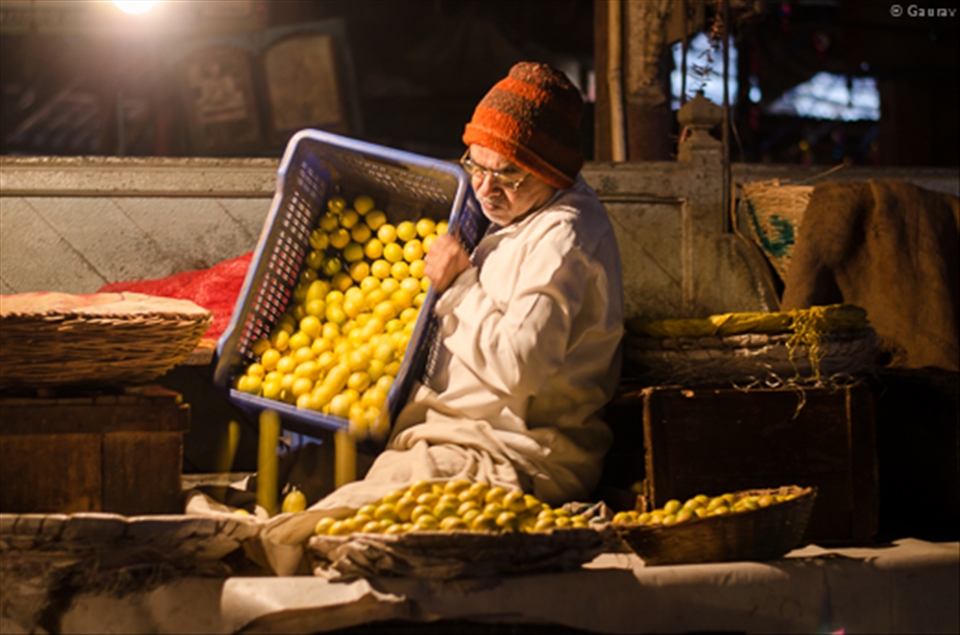 Business starts early morning for all men in the oldest vegetable market in the city.This old man is setting up his lemon shop for the day at the Mandai Vegetable market.
