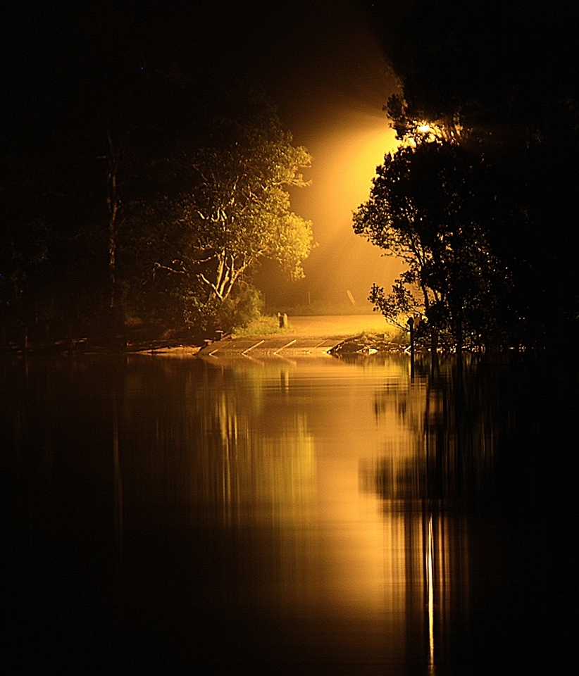 A street light shining down on the cable ferry ramp. The ferry takes cars across the Hastings river at Port Macquarie.