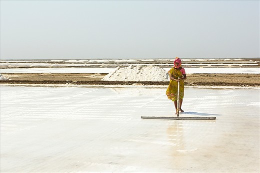 Saltpan workers of the Little Rann of Kutch, Gujurat, India
We arrived in the hottest part of the dry season and all the surface water had gone in the months previous, briny water is pumped from underground water deposits. The saline water is 10 times saltier than sea water. It is pumped into the huge salt pans carved into the desert floor and is harvested on an industrial scale. Raked continually to separate, allow evaporation and to encourage formation of the salt crystals. 