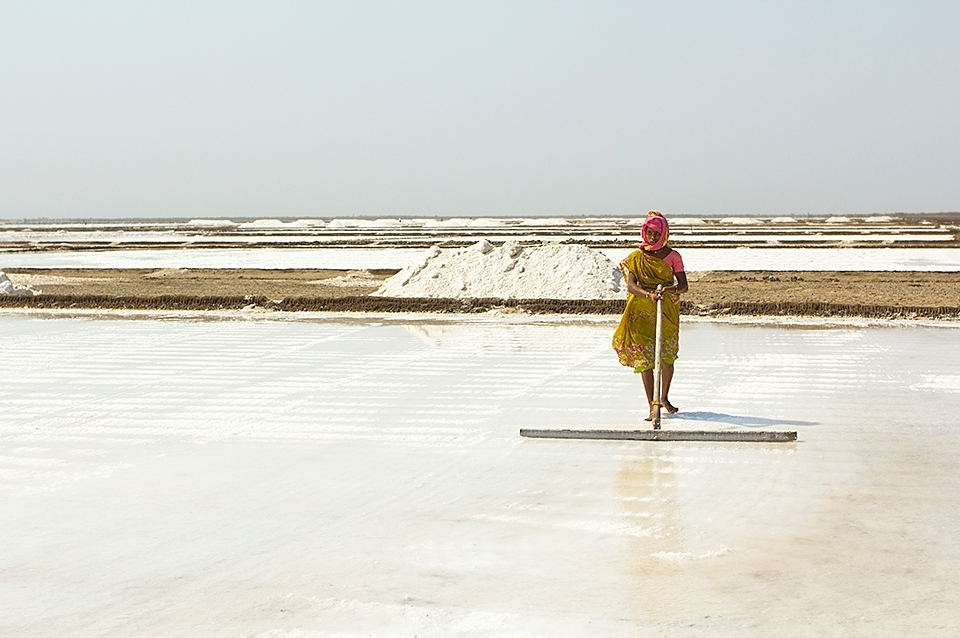 Saltpan workers of the Little Rann of Kutch, Gujurat, India
We arrived in the hottest part of the dry season and all the surface water had gone in the months previous, briny water is pumped from underground water deposits. The saline water is 10 times saltier than sea water. It is pumped into the huge salt pans carved into the desert floor and is harvested on an industrial scale. Raked continually to separate, allow evaporation and to encourage formation of the salt crystals. 
