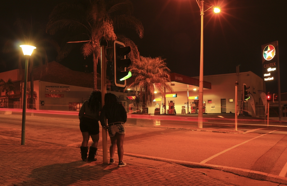 It’s either you stop for the traffic lights, Caltex or uuhm…sex. Two hours before midnight, Monica and Lucia are patiently waiting in the cold to feed lustful motorists for only 100 ZAR. A passing car draws neon lights which customize this self-styled Red light District, and a line which is also a danger tape warning about a health hazard. This province has the second highest HIV/AIDS prevalence rate in the country.