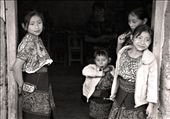 Village girls stand in the doorstep to their house.  Wonder upon their faces, beauty in their eyes; they speak a local native language that can only be learned when growing up in this mystical town.: by gcmfoto, Views[1052]