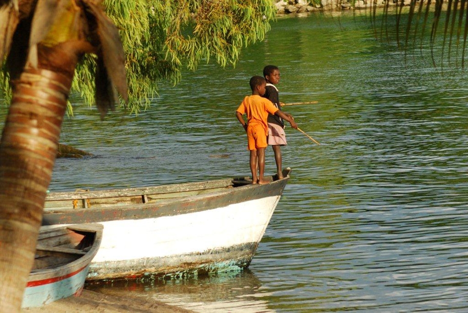 The happy carefree youth practice their fishing from the shore.
