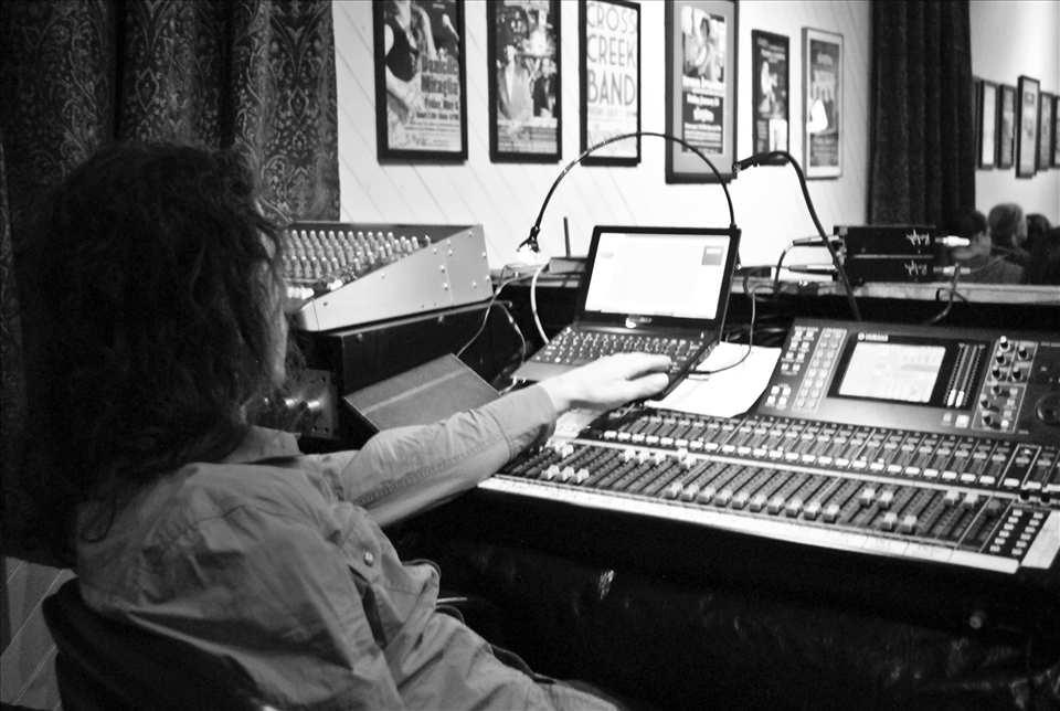 3) Making last minute adjustments before the show, the sound-man at his most relaxed. Promotional posters line the walls and the audience anticipates the start of another night to remember.
Nelson, NY