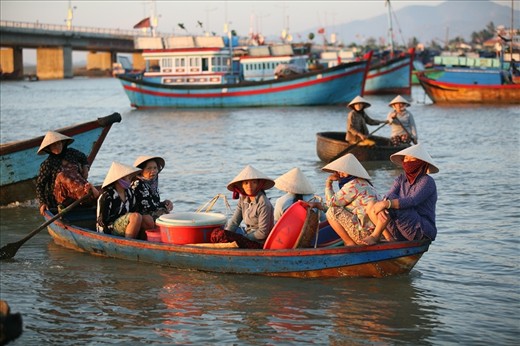 Woke up at 4:30am to visit a local fish market in Nha Trang, situated on a small sand bar on the Cai River to capture the hustle and bustle of the morning activities.  Morning sun breaking on a shore boat transferring the catch to the waiting buyers.