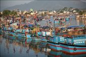 The colourful motorised fishing vessel of Nha Trang glistering in the early morning rays.  Fishermen resting before heading out for a couple days to fill their nets with the next catch for sale at this informal market.: by george2georgiou, Views[470]