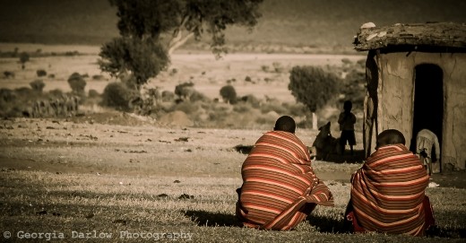 A couple of Maasai tribesmen take some time out in the Maasai Mara, Kenya