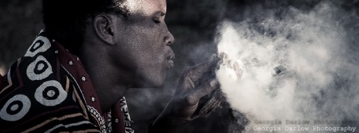A Maasai tribesman makes fire