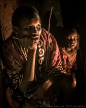 Members of a Maasai family sit inside a house, lit with only the light of the fire. : by georgi_kate, Views[423]