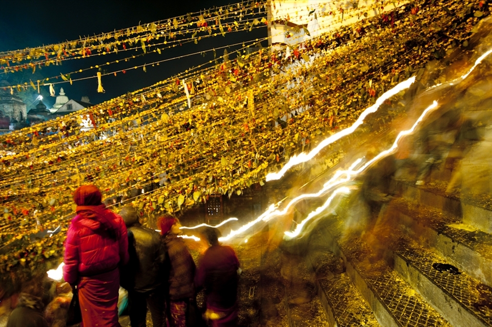 People light traditional oil lamp (diyo) and recite mantras. They keep awake all night to ensure that the lamp keeps burning. After walking inside the temple throwing 7 different kind of sacred seeds, devotees walk to the river Bagmati where the oil candles are released