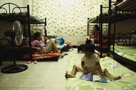 Jen (not her real name), diagnosed with lymphoma, reads a storybook inside one of the dormitory rooms while waiting for her doctor's appointment. Four to five families share living quarters, making it quite cramped and uncomfortable. It does however establish a community feel, especially among the parents who are constantly chattering and sharing experiences as if in a PTA meeting.